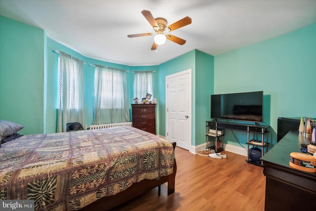 bedroom with ceiling fan and hardwood / wood-style flooring