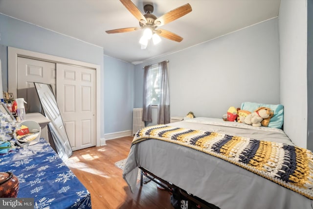 bedroom with a closet, ceiling fan, and light wood-type flooring