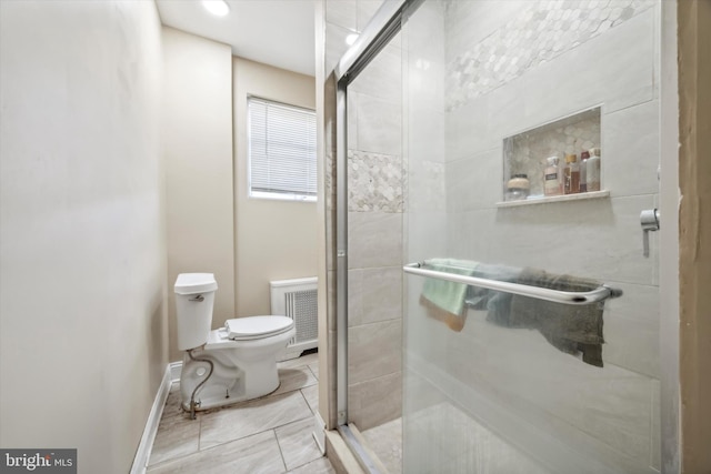 bathroom with toilet and a shower with shower door