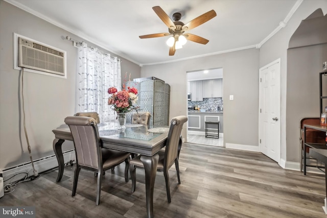 dining room with a wall mounted air conditioner, ornamental molding, hardwood / wood-style flooring, and ceiling fan