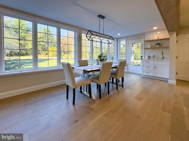 dining area with plenty of natural light and light wood-type flooring