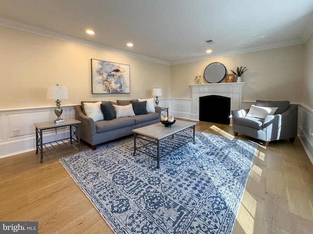 living room featuring crown molding and light wood-type flooring