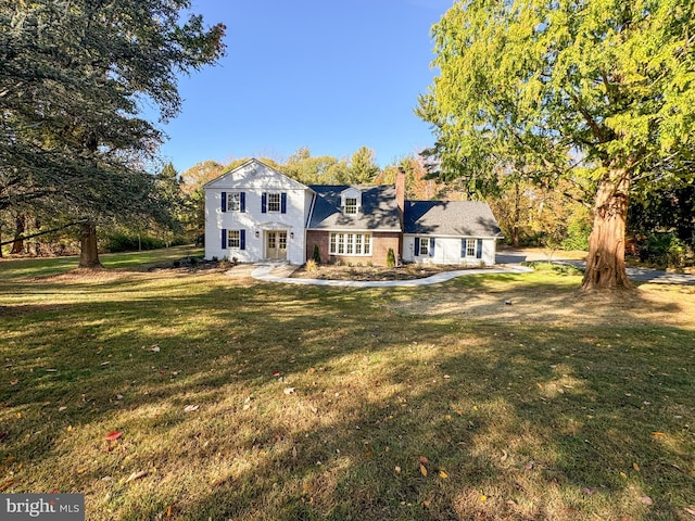 rear view of house featuring a lawn