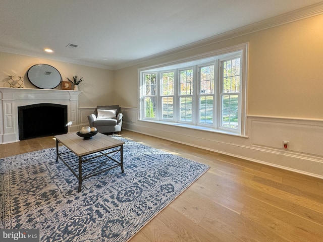 living room featuring ornamental molding, hardwood / wood-style flooring, and plenty of natural light