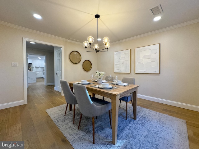 dining room featuring crown molding and wood-type flooring