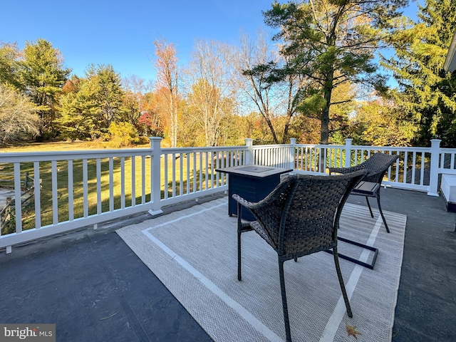 wooden terrace with a lawn