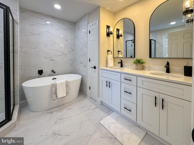 bathroom featuring vanity, tile walls, and separate shower and tub