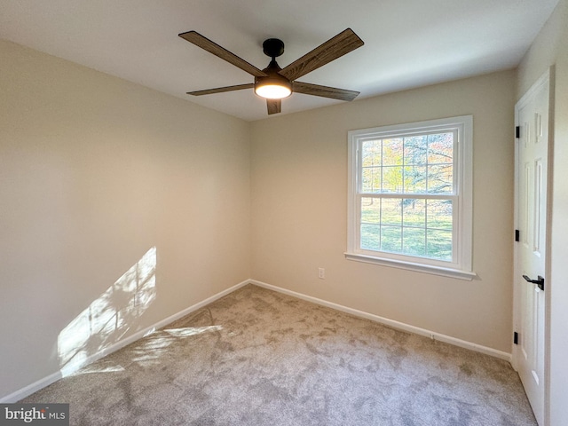 empty room with light colored carpet and ceiling fan