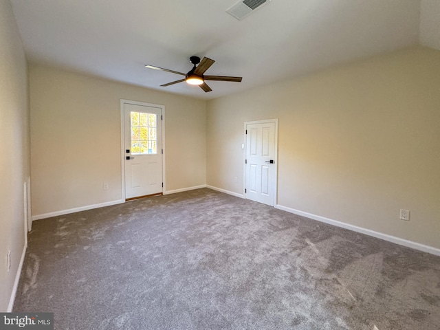 unfurnished room featuring ceiling fan, carpet flooring, and vaulted ceiling