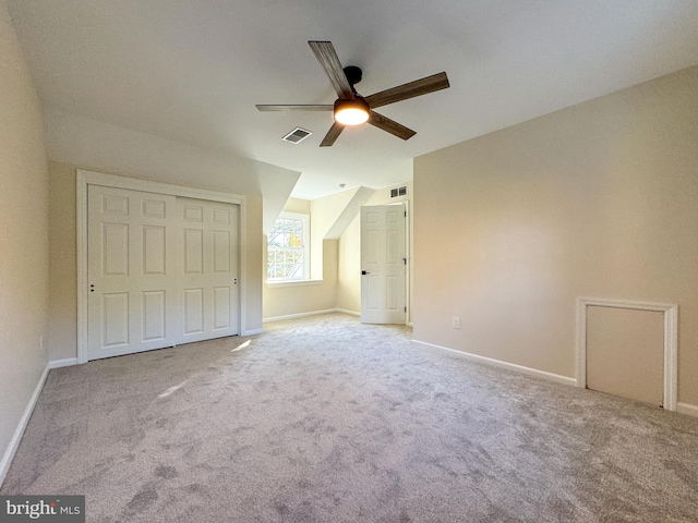 unfurnished bedroom featuring light carpet, a closet, and ceiling fan