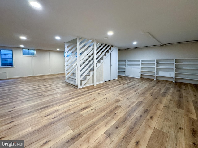 basement with light hardwood / wood-style floors