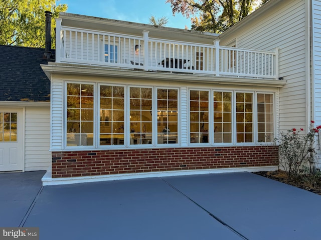 back of property with a patio area and a balcony