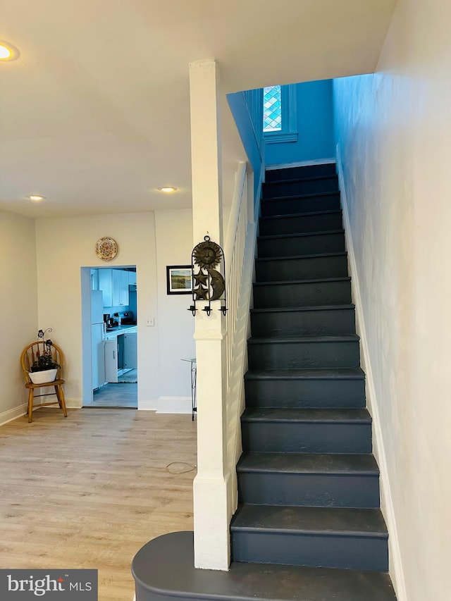 staircase featuring wood-type flooring