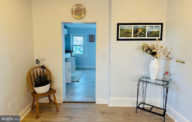 hallway with light hardwood / wood-style floors