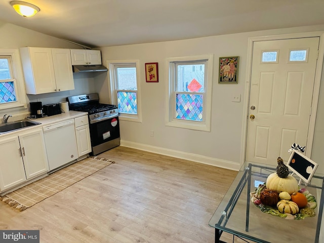 kitchen featuring dishwasher, white cabinets, sink, gas range, and light wood-type flooring