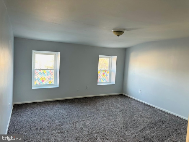 carpeted empty room with a wealth of natural light