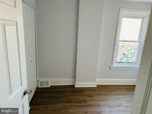 spare room featuring dark hardwood / wood-style floors