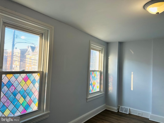 spare room featuring dark hardwood / wood-style flooring