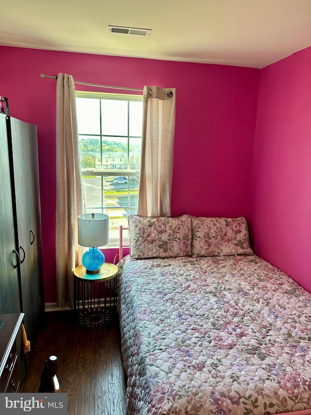 bedroom with dark wood-type flooring