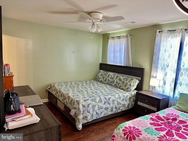 bedroom with ceiling fan and dark hardwood / wood-style floors