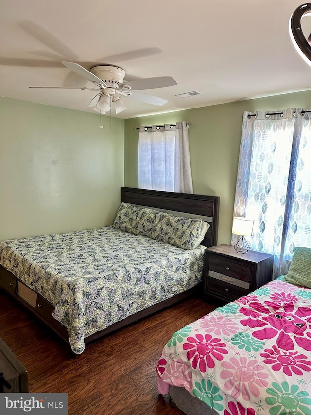 bedroom with ceiling fan and dark hardwood / wood-style flooring