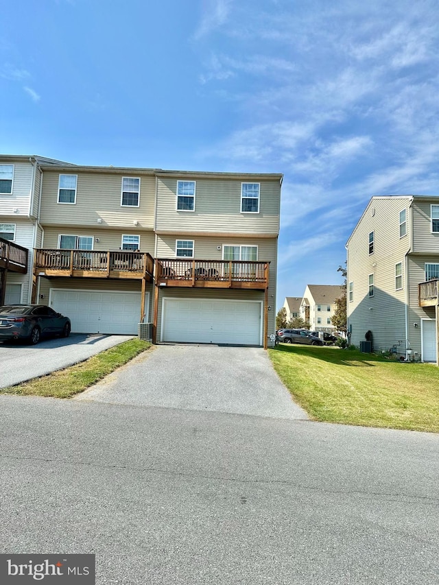 view of front of home with central AC and a garage