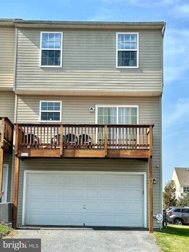 view of front facade with a balcony and a garage