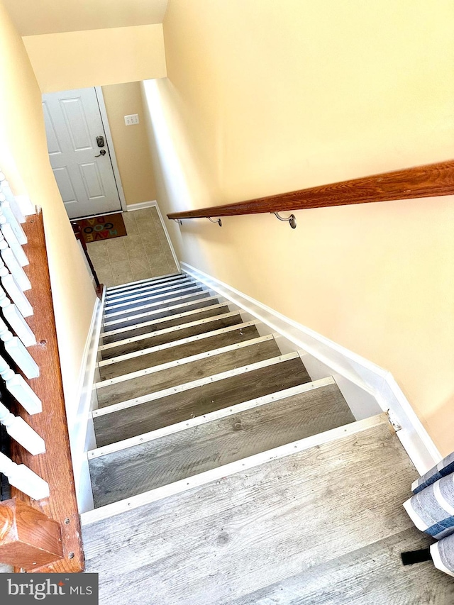 stairs with hardwood / wood-style floors