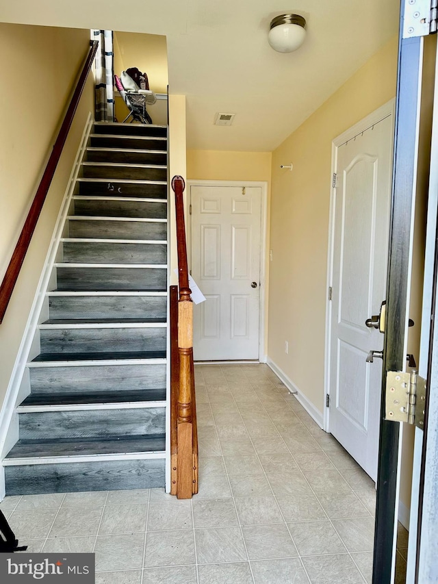 stairs featuring tile patterned floors