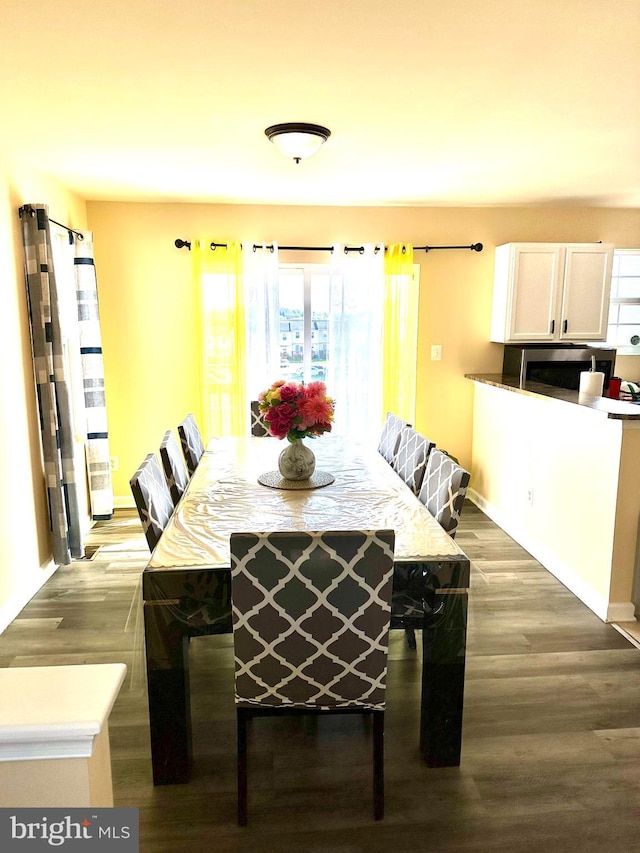 dining area featuring dark wood-type flooring