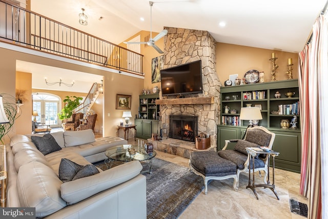 living room featuring high vaulted ceiling, ceiling fan, and a fireplace