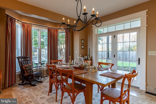 dining room with a notable chandelier and baseboards