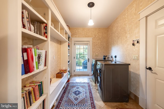 washroom featuring washer and clothes dryer, laundry area, and wallpapered walls