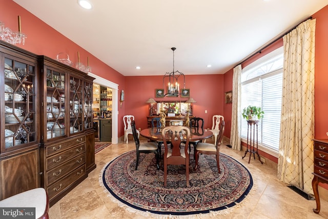 dining space with an inviting chandelier, beverage cooler, recessed lighting, and visible vents