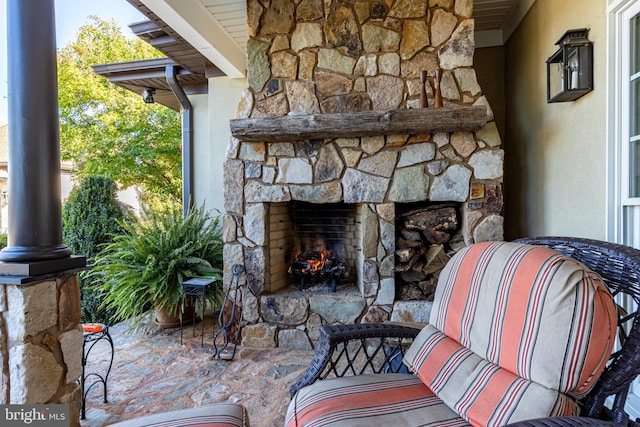 view of patio with an outdoor stone fireplace