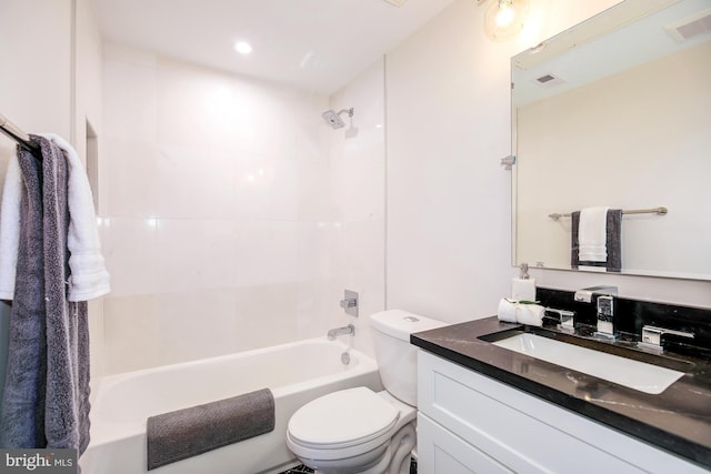 full bathroom with vanity, toilet, and tiled shower / bath