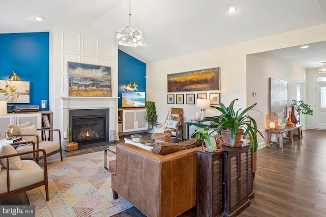 living room with wood-type flooring, lofted ceiling, and a chandelier