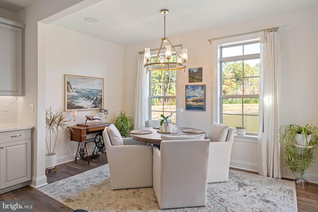 dining space featuring a chandelier and dark hardwood / wood-style flooring