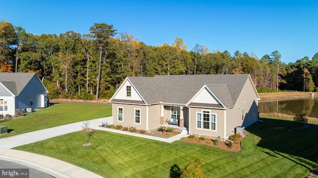 view of front of property featuring a front yard and central AC