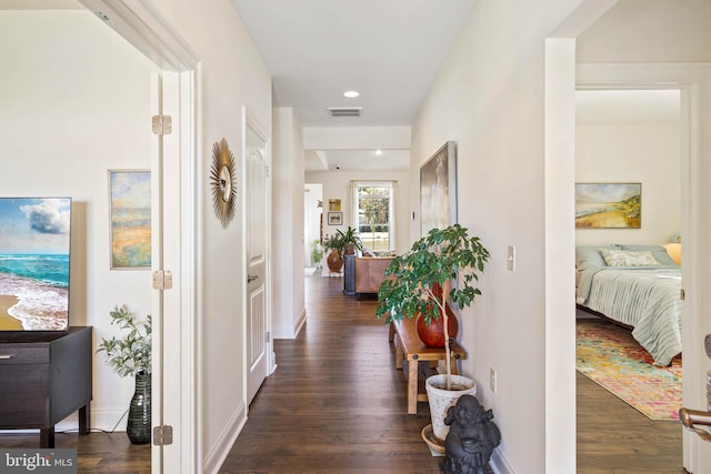 hallway with dark hardwood / wood-style flooring