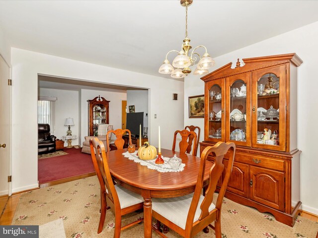 dining space with an inviting chandelier