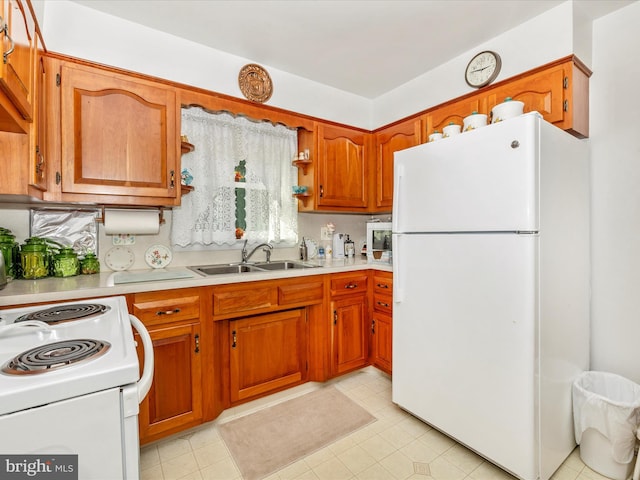 kitchen with sink, white appliances, and tasteful backsplash