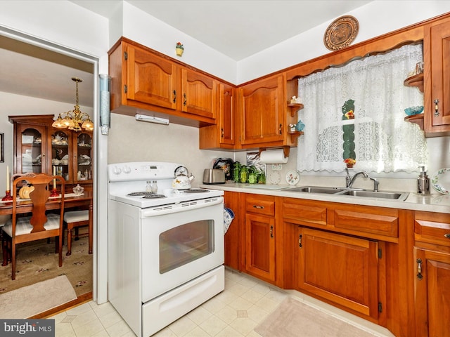 kitchen with a notable chandelier, white electric range, and sink