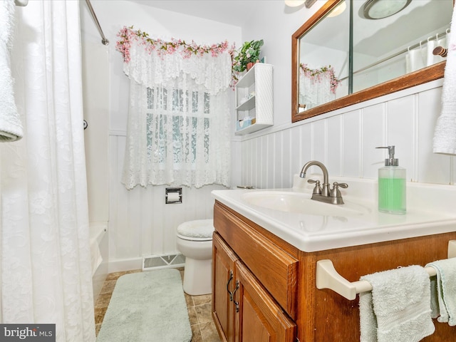 full bathroom featuring vanity, shower / bath combo with shower curtain, toilet, and tile patterned floors