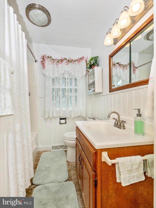 full bathroom with vanity, toilet, tile patterned floors, and shower / bathtub combination with curtain