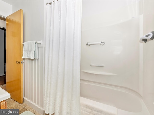 bathroom with shower / bath combination with curtain