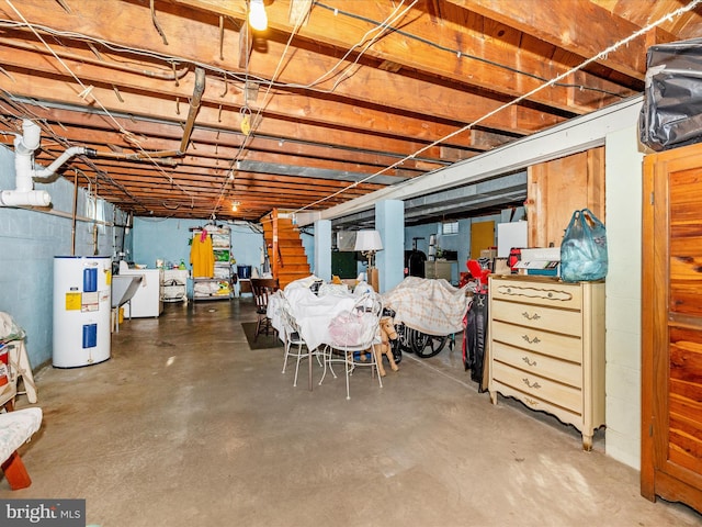 basement featuring electric water heater and washer / clothes dryer