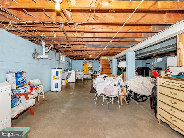 basement featuring washer / clothes dryer, electric water heater, and sink