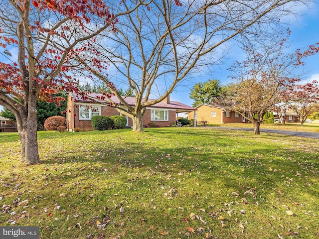 ranch-style home with a front lawn