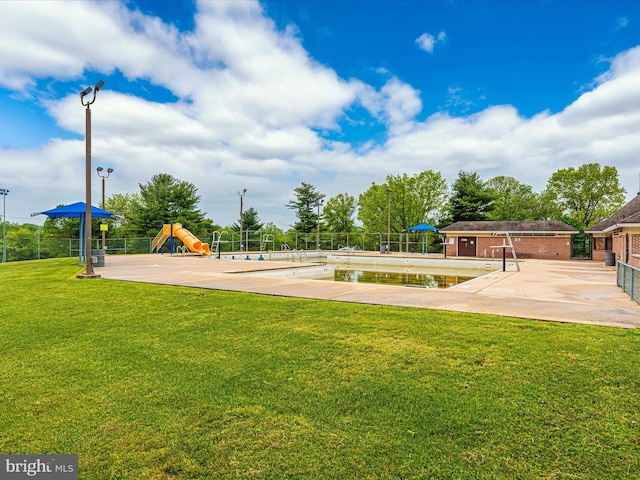 view of home's community with a playground and a yard